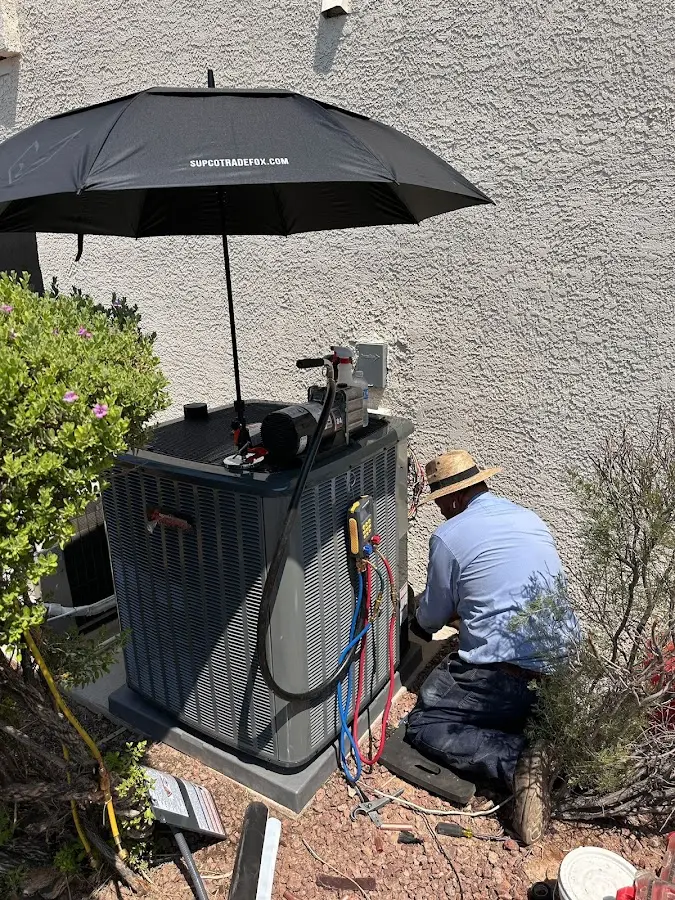 HVAC technician performing outdoor AC maintenance in Anderson